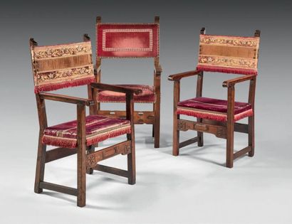 null Pair of walnut armchairs; high backrests with bracketed pinnacles; scrolled...