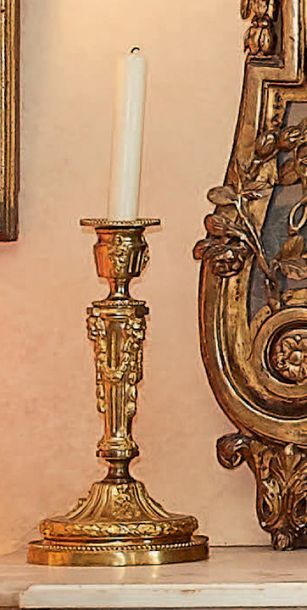 null Pair of chased and gilt bronze torches, decorated with flowers and lion mittens...