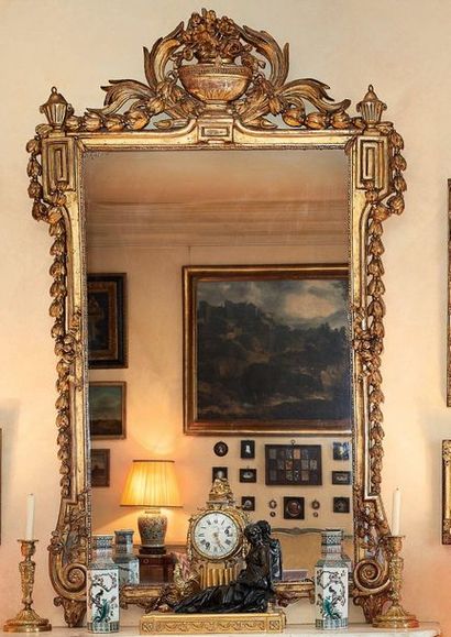 null Carved and gilded wooden mirror, decorated with greek, flowers and garlands,...
