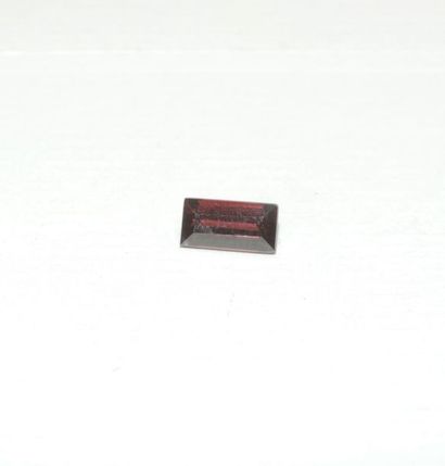 null A rectangular rhodolite garnet with stepped-cut sides. Dimensions: approx. 8...