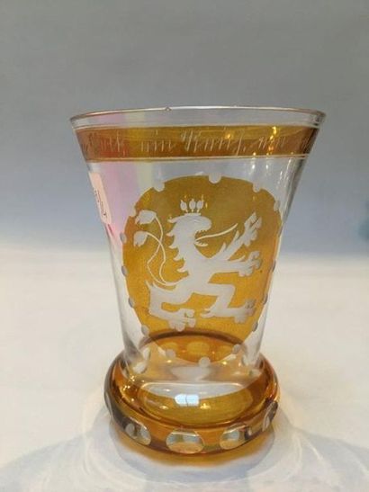 null Glass with lion decoration on a yellow background 

Height: 10 cm