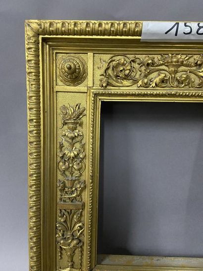 null Carved and gilded wood frame with openwork and floral pilasters and a gadroon...