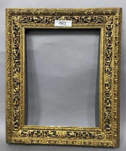 null Carved and gilded wood frame with openwork scrolls decoration on a green background.

Italian...