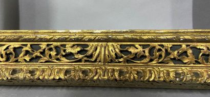 null Carved and gilded wood frame with openwork scrolls decoration on a green background.

Italian...