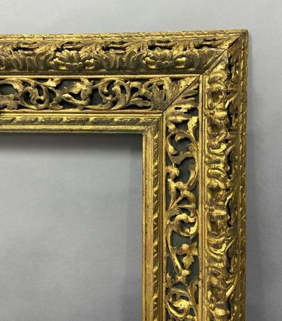 null Carved and gilded wood frame with openwork scrolls decoration on a green background.

Italian...