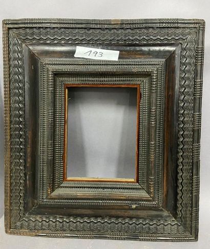 null Blackened moulded wooden frame with an upside-down profile and decorated with...