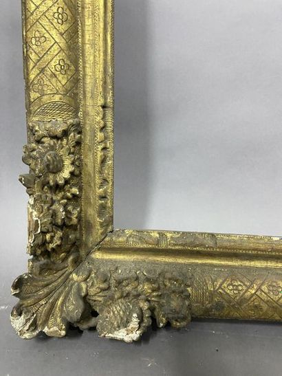 null Sculpted and gilded oak frame with corner decoration of flowers and fleur-de-lys...