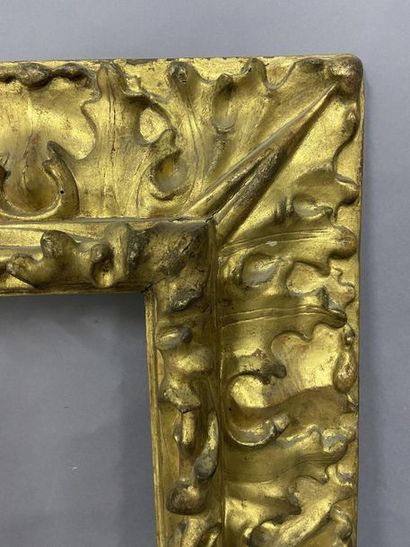  Sculpted and gilded lindenwood frame with an upside-down profile and rich acanthus...