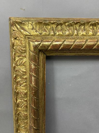 null Carved and gilded wooden frame with an upside-down profile, ribbon decoration...