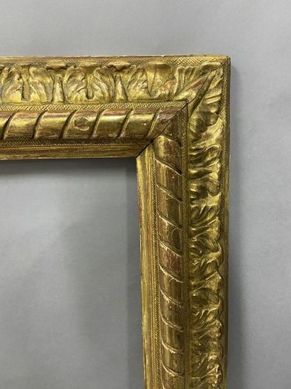 null Carved and gilded wooden frame with an upside-down profile, ribbon decoration...