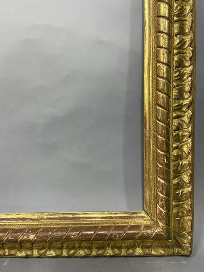 null Carved and gilded wooden frame with an upside-down profile, ribbon decoration...