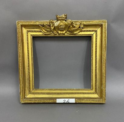 Sculpted and gilded oak frame with a crowned...