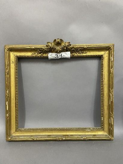 null Carved and gilded wooden frame with beaded grape decoration, ribbons and mantling...