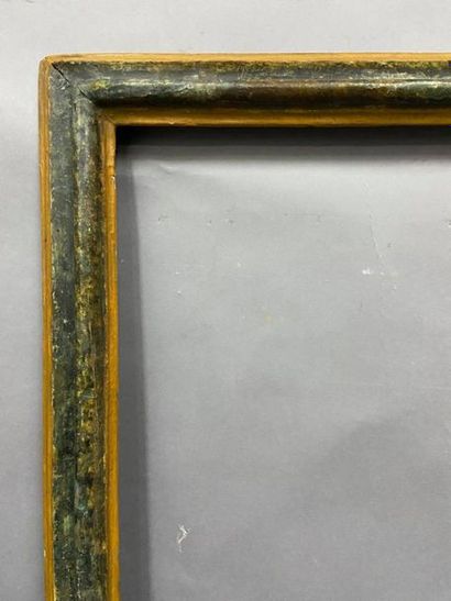 null Moulded wooden frame with upside down profile and green and yellow marble decoration

Italy,...