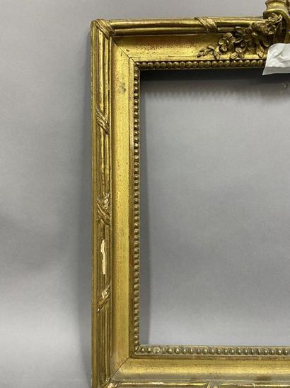 null Carved and gilded wooden frame with beaded grape decoration, ribbons and mantling...