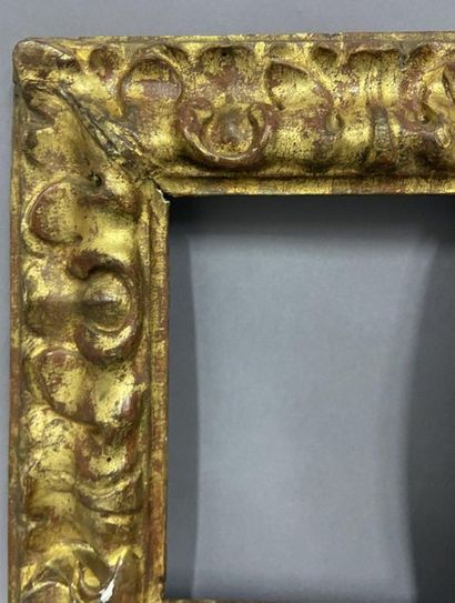 null Wooden, carved and gilded frame with an upside-down profile and a water leaf...