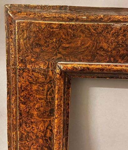 null *Reverse profile moulded wooden frame with painted decoration in imitation of...