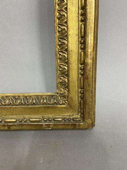 null Carved and gilded oak frame decorated with laurel scrolls and garlands in pediment

Louis...