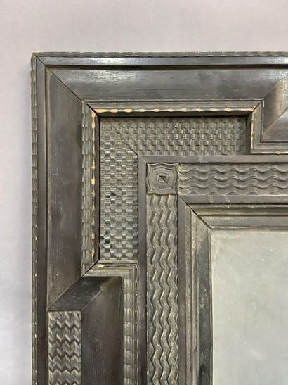 null Moulded and blackened wooden frame decorated with recessed corners and guilloche...