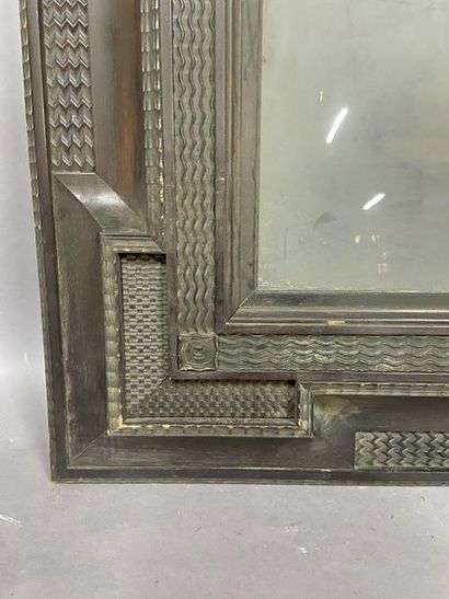 null Moulded and blackened wooden frame decorated with recessed corners and guilloche...