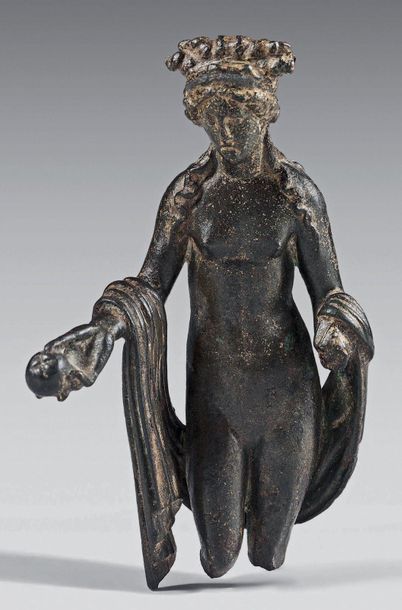 null Statuette of naked Venus holding an apple in her right hand. She is holding...