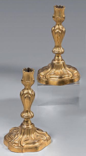 null Pair of candlesticks in chased and gilt bronze; the bobèches and three-faceted...