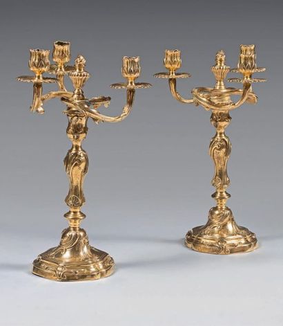 null Pair of chased, engraved and gilded bronze three-light candelabra; the bouquets...