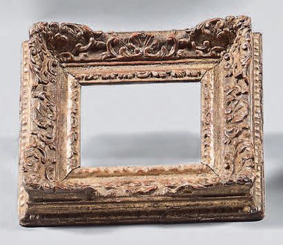 null Moulded, carved and gilded miniature oak frame with rinceaux and shells decoration;...