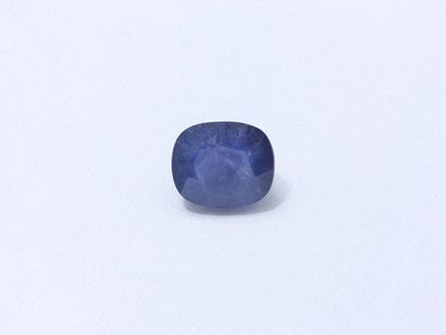 null Cushion size sapphire on paper weighing 12.47 cts.
