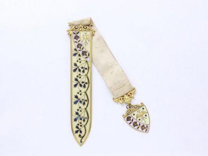null Bookmark serving as a letter opener in gold metal enamelled in full cream colour...