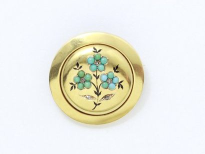 null 750-thousandths gold brooch, round in shape, decorated with flowers punctuated...