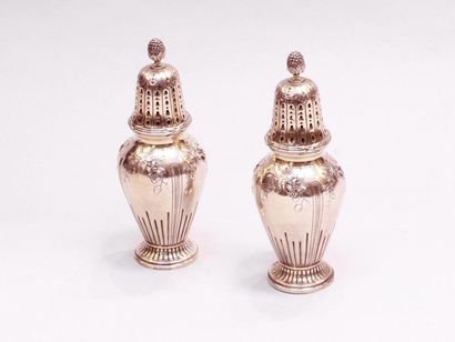 null Pair of silver sprinklers, the pedestals and base of the fluted bodies, the...