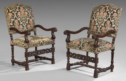null Pair of large walnut armchairs richly carved and turned. The sinuous armrests...