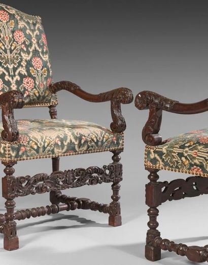 null Pair of large walnut armchairs richly carved and turned. The sinuous armrests...