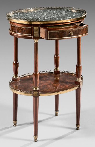 null Small writing table in mahogany veneer or yew burr; oval in shape, it opens...