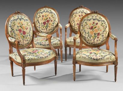 null Suite of four flat-backed armchairs in moulded and carved walnut medallion with...