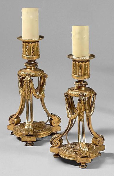 null Pair of chiselled and gilt bronze candleholders; the bobèches with channels...