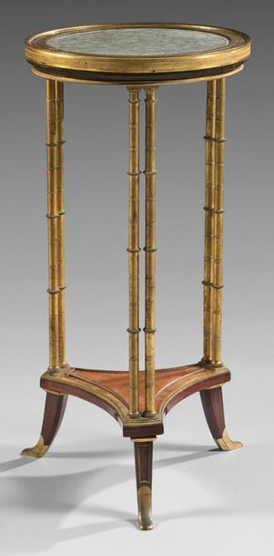 null Pedestal table in mahogany, gilded bronze and ambony burr veneer; the recessed...