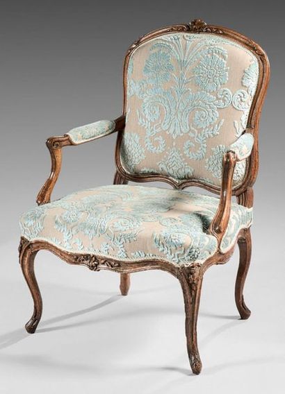 null Armchair with a flat back in natural wood moulded and carved with flowers and...