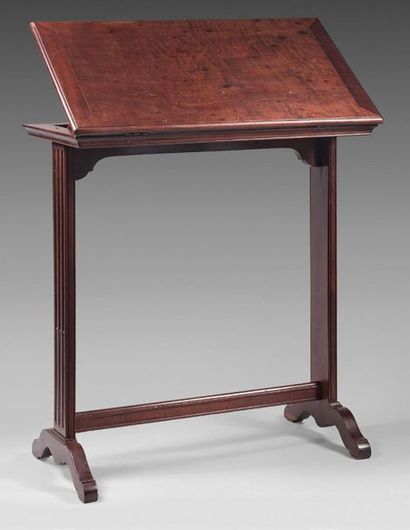 null Mahogany reading table. The rectangular top is rack and pinion shaped and has...