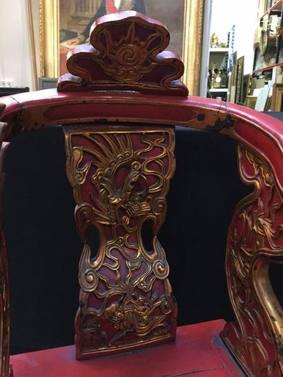 VIETNAM Child's throne in carved wood, red and gold lacquered, the armrests ending...