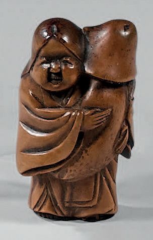JAPON Carved wooden Netsuke representing Okame holding a mushroom. Bears the Hojitsu...