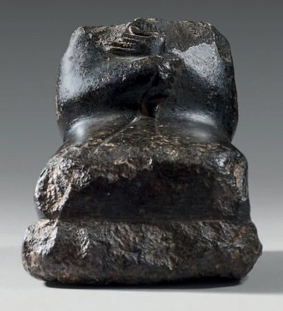 null Headless statuette sitting in a suit and wrapped in a cloak.
Diorite.
Egypt,...