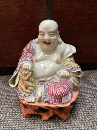 CHINE Figurine representing a porcelain Buddha sitting on an openwork mound in imitation...