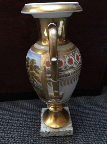 PARIS Porcelain baluster-shaped vase on a gilded pedestal resting on a square counter-base...
