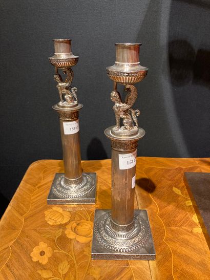  PAIR OF SILVER TORCHES. 
Empire style, the square base, the columnar shaft summoned...