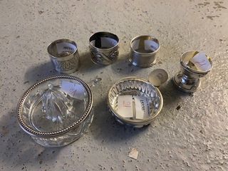 null Silver lot including a citrus press, a wine taster, an egg cup and 3 napkin...