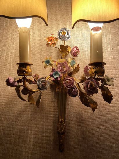 null Three ormolu sconces with two light arms decorated with porcelain flowers 

Louis...