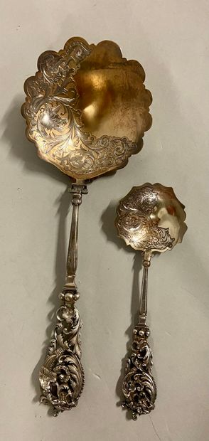 null 
Serving spoon and small silver spoon, chiselled decoration of wolf and dragon...
