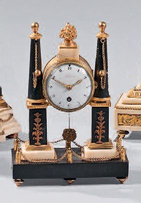  Small clock called "portico" in chased and gilt bronze and black and white marble;...